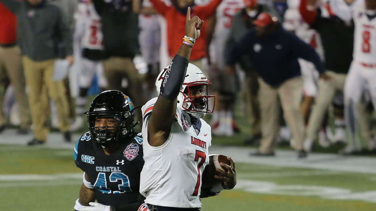 ORLANDO, FL - DECEMBER 26: Liberty Flames quarterback Malik Willis (7) runs for a touchdown during the FBC Mortgage Cure Bowl game between the Liberty Flames and the Coastal Carolina Chanticleers on December 26, 2020 at Camping World Stadium in Orlando, Fl.