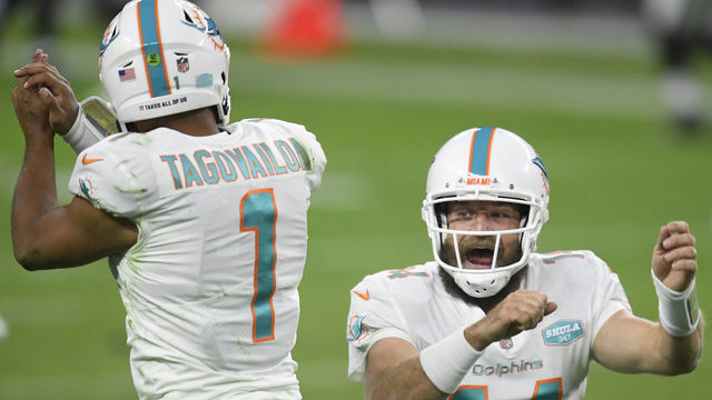 LAS VEGAS, NEVADA - DECEMBER 26: Ryan Fitzpatrick #14 of the Miami Dolphins celebrates his touchdown pass with Tua Tagovailoa #1, to take a 23-22 lead over the Las Vegas Raiders, during the fourth quarter at Allegiant Stadium on December 26, 2020 in Las Vegas, Nevada.