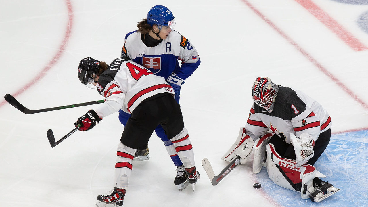 EDMONTON, AB - DECEMBER 27: Bowen Byram #4 and goaltender Devon Levi #1 of Canada defend against Michal Mrazik #25 of Slovakia during the 2021 IIHF World Junior Championship at Rogers Place on December 27, 2020 in Edmonton, Canada.