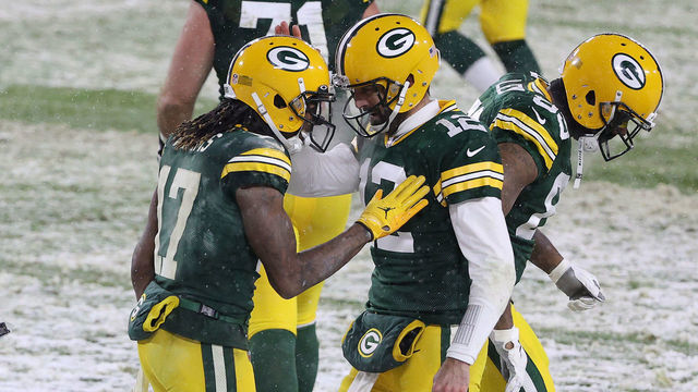 GREEN BAY, WISCONSIN - DECEMBER 27: Quarterback Aaron Rodgers #12 of the Green Bay Packers celebrates a touchdown with Davante Adams #17 against the Tennessee Titans during the third quarter at Lambeau Field on December 27, 2020 in Green Bay, Wisconsin.