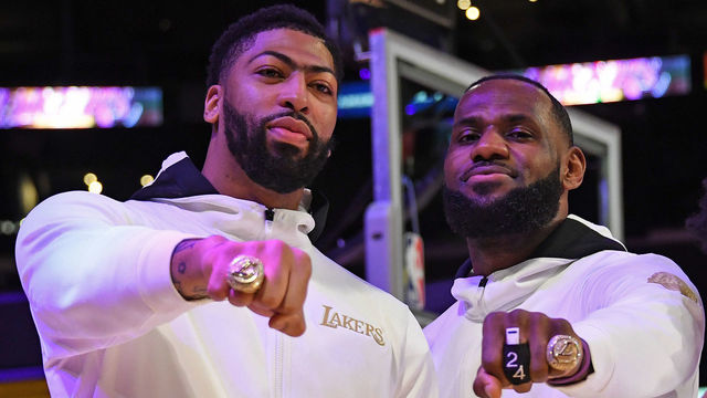 LOS ANGELES, CA - DECEMBER 22: Anthony Davis #3, LeBron James #23 and Quinn Cook #2 of the Los Angeles Lakers pose for a photo as they get their 2019-20 NBA Championship ring during the ring ceremony before the game against the LA Clippers on December 22, 2020 at STAPLES Center in Los Angeles, California. NOTE TO USER: User expressly acknowledges and agrees that, by downloading and/or using this Photograph, user is consenting to the terms and conditions of the Getty Images License Agreement. Mandatory Copyright Notice: Copyright 2020 NBAE