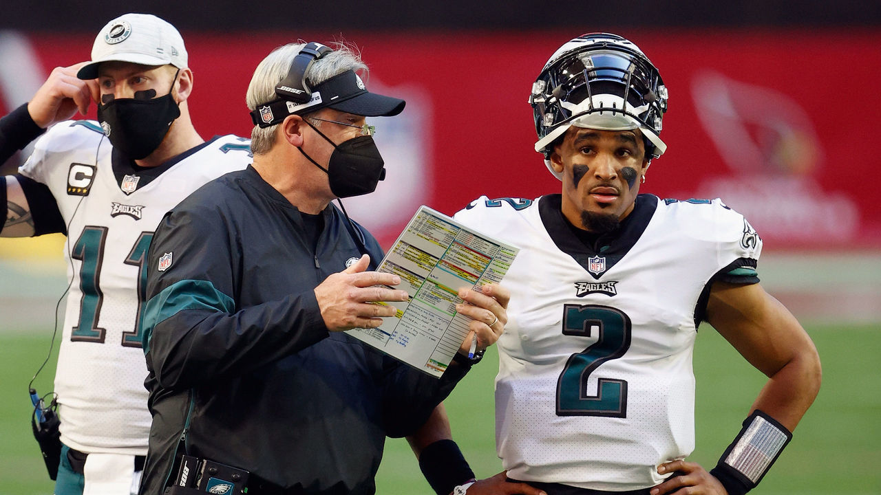 GLENDALE, ARIZONA - DECEMBER 20: Head coach Doug Pederson of the Philadelphia Eagles talks with quarterback Jalen Hurts #2 during the second quarter against the Arizona Cardinals at State Farm Stadium on December 20, 2020 in Glendale, Arizona.