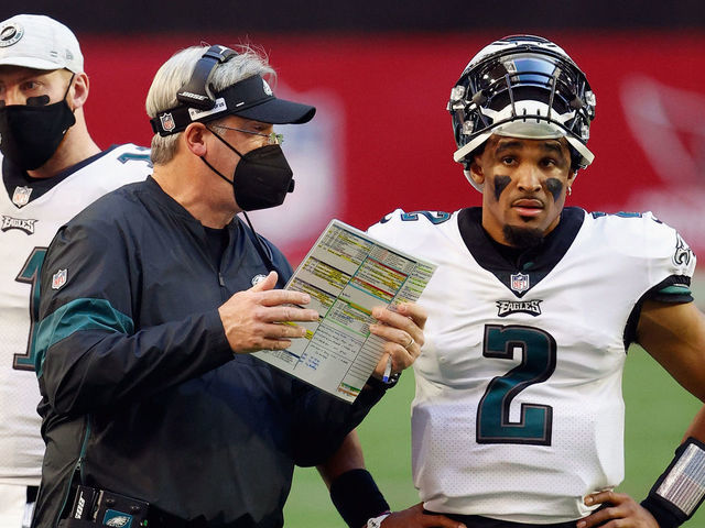 GLENDALE, ARIZONA - DECEMBER 20: Head coach Doug Pederson of the Philadelphia Eagles talks with quarterback Jalen Hurts #2 during the second quarter against the Arizona Cardinals at State Farm Stadium on December 20, 2020 in Glendale, Arizona.