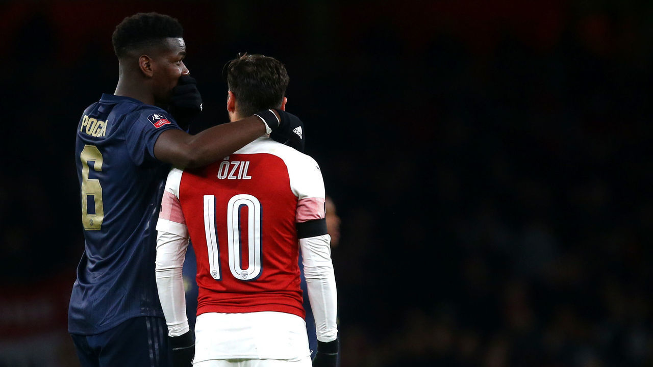 LONDON, ENGLAND - JANUARY 25: Paul Pogba of Manchester United and Mesut Ozil of Arsenal talk together at the end of the 4th round match between Arsenal and Manchester United at The Emirates Stadium on January 25, 2019 in London, United Kingdom.