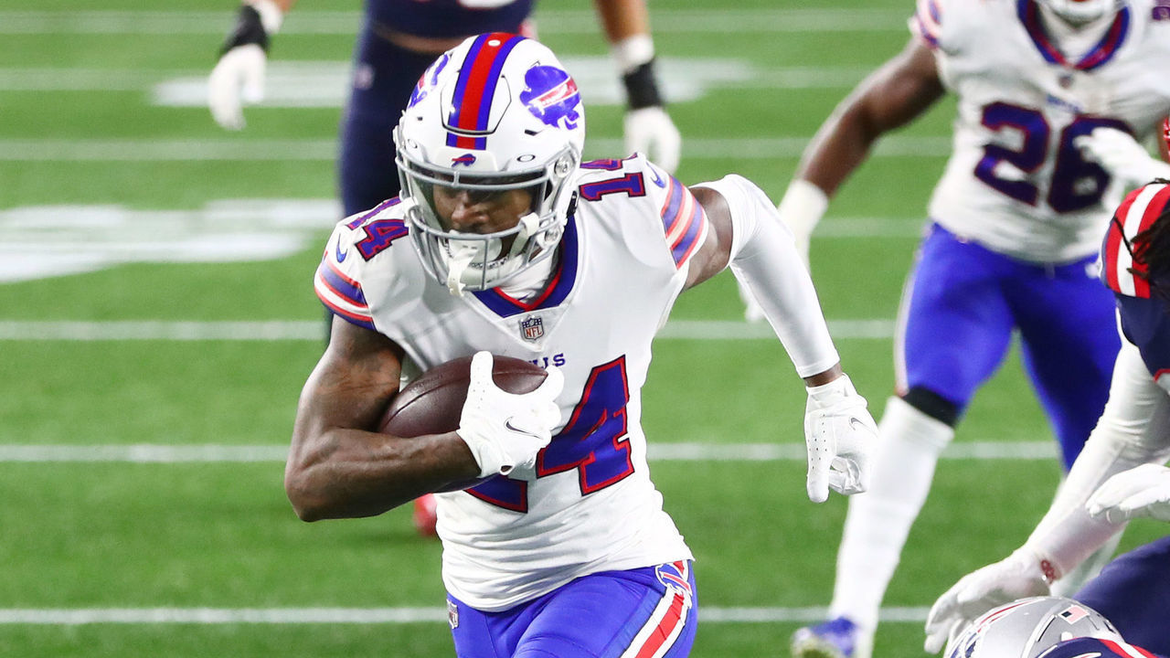 FOXBOROUGH, MASSACHUSETTS - DECEMBER 28: Stefon Diggs #14 of the Buffalo Bills avoids a tackle by Terrence Brooks #25 of the New England Patriots to run the ball in for a touchdown during the second half at Gillette Stadium on December 28, 2020 in Foxborough, Massachusetts.