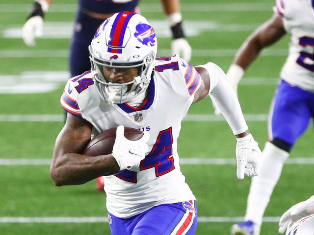 FOXBOROUGH, MASSACHUSETTS - DECEMBER 28: Stefon Diggs #14 of the Buffalo Bills avoids a tackle by Terrence Brooks #25 of the New England Patriots to run the ball in for a touchdown during the second half at Gillette Stadium on December 28, 2020 in Foxborough, Massachusetts.