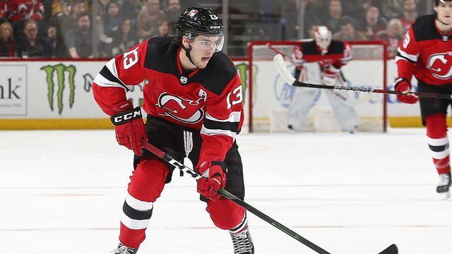 NEWARK, NJ - MARCH 10: Nico Hischier #13 of the New Jersey Devils plays the puck against the Pittsburgh Penguins during the game at the Prudential Center on March 10, 2020 in Newark, New Jersey. "n"n"n