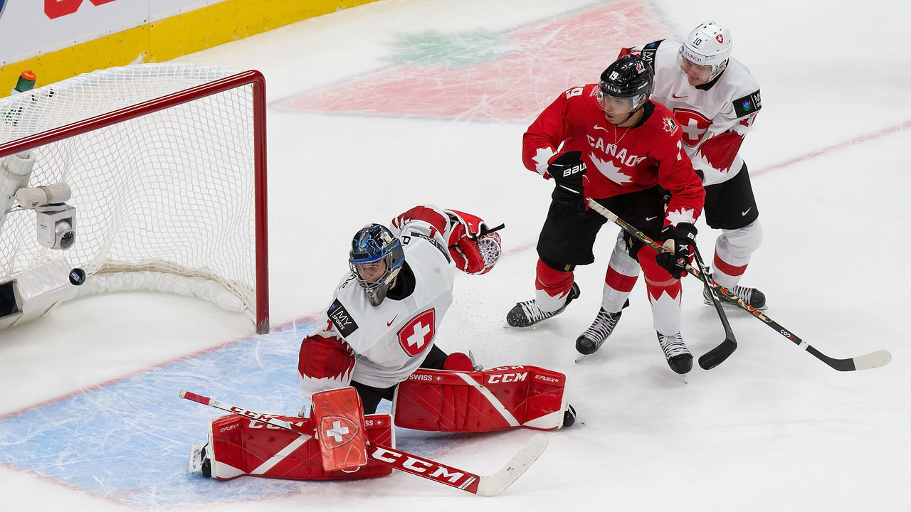 EDMONTON, AB - DECEMBER 29: Quinton Byfield #19 of Canada looks on as goaltender Noah Patenaude #1 of Switzerland blocks a shot during the 2021 IIHF World Junior Championship at Rogers Place on December 29, 2020 in Edmonton, Canada.