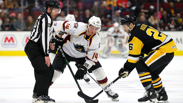 CLEVELAND, OH - DECEMBER 13: Cleveland Monsters left wing Jakob Lilja (14) and Wilkes-Barre/Scranton Penguins left wing Andrew Agozzino (26) battle for a faceoff during the second period of the American Hockey League game between the Wilkes-Barre/Scranton Penguins and Cleveland Monsters on December 13,2019, at Rocket Mortgage FieldHouse in Cleveland, OH.