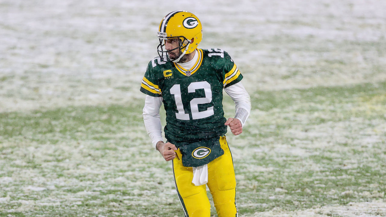 GREEN BAY, WISCONSIN - DECEMBER 27: Aaron Rodgers #12 of the Green Bay Packers celebrates after scoring a touchdown in the second quarter against the Tennessee Titans at Lambeau Field on December 27, 2020 in Green Bay, Wisconsin.