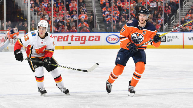 EDMONTON, AB - JANUARY 19: Connor McDavid #97 of the Edmonton Oilers races for the puck against Johnny Gaudreau #13 of the Calgary Flames on January 19, 2019 at Rogers Place in Edmonton, Alberta, Canada.
