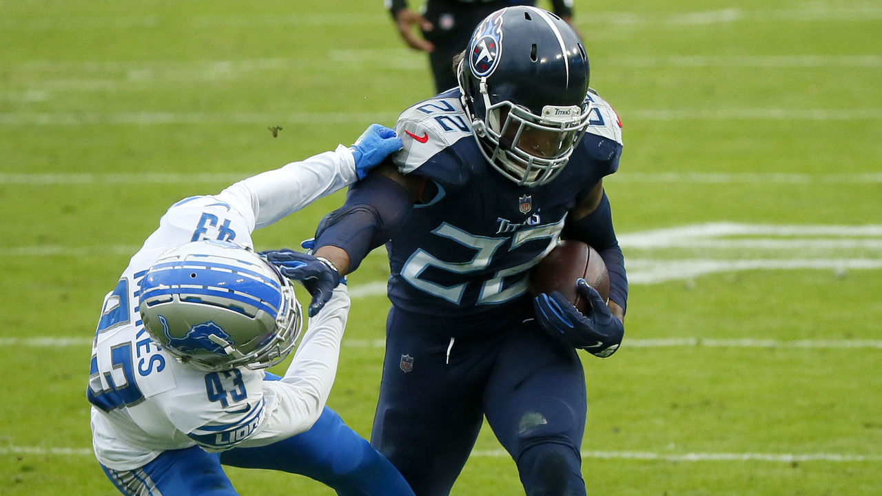 NASHVILLE, TENNESSEE - DECEMBER 20: Running back Derrick Henry #22 of the Tennessee Titans stiff arms cornerback Alexander Myers#43 of the Detroit Lions during the second quarter of the game at Nissan Stadium on December 20, 2020 in Nashville, Tennessee.