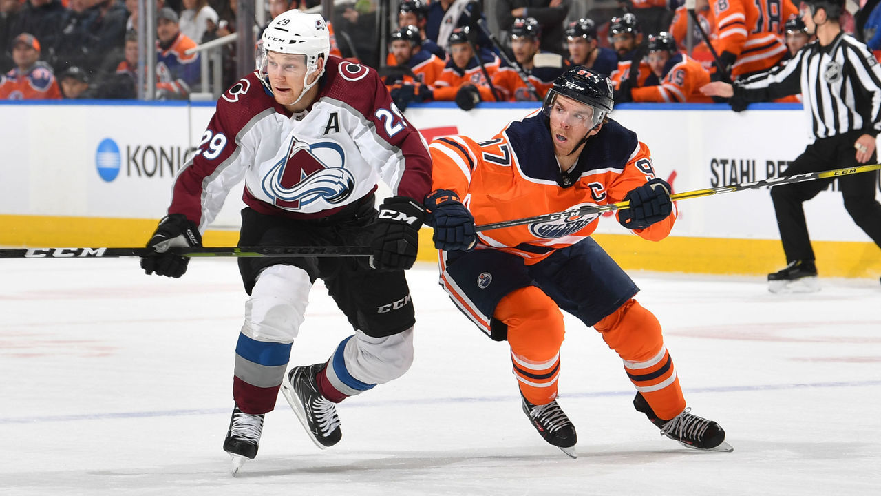EDMONTON, AB - NOVEMBER 14: Connor McDavid #97 of the Edmonton Oilers races for the puck against Nathan MacKinnon #29 of the Colorado Avalanche on November 14, 2019, at Rogers Place in Edmonton, Alberta, Canada.