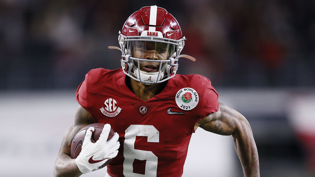 ARLINGTON, TEXAS - JANUARY 01: Wide receiver DeVonta Smith #6 of the Alabama Crimson Tide rushes for a touchdown over the defense of Notre Dame Fighting Irish during the second quarter of the 2021 College Football Playoff Semifinal Game at the Rose Bowl Game presented by Capital One at AT&T Stadium on January 01, 2021 in Arlington, Texas.