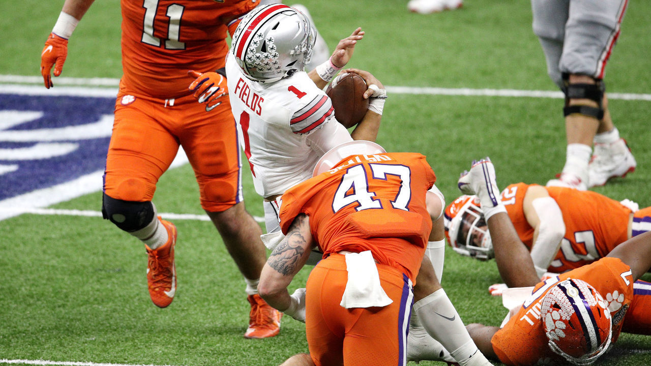 NEW ORLEANS, LOUISIANA - JANUARY 01: Justin Fields #1 of the Ohio State Buckeyes is tackled by James Skalski #47 of the Clemson Tigers in the second quarter during the College Football Playoff semifinal game at the Allstate Sugar Bowl at Mercedes-Benz Superdome on January 01, 2021 in New Orleans, Louisiana.