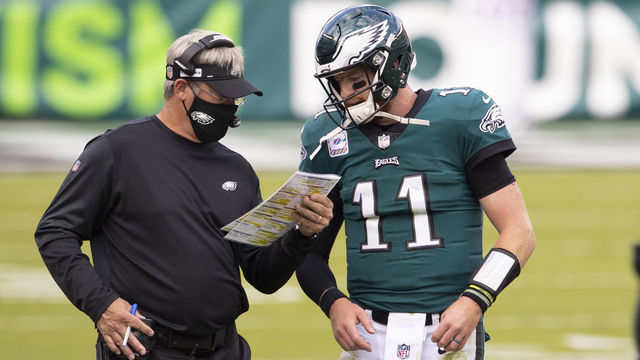 PHILADELPHIA, PA - OCTOBER 18: Head coach Doug Pederson of the Philadelphia Eagles talks to Carson Wentz #11 against the Baltimore Ravens at Lincoln Financial Field on October 18, 2020 in Philadelphia, Pennsylvania.