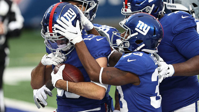 EAST RUTHERFORD, NEW JERSEY - JANUARY 03: Dante Pettis #13 of the New York Giants is congratulated by Evan Engram #88, Dion Lewis #33 and Cameron Fleming #75 after scoring on a 33-yard touchdown reception against the Dallas Cowboys during the second quarter at MetLife Stadium on January 03, 2021 in East Rutherford, New Jersey.