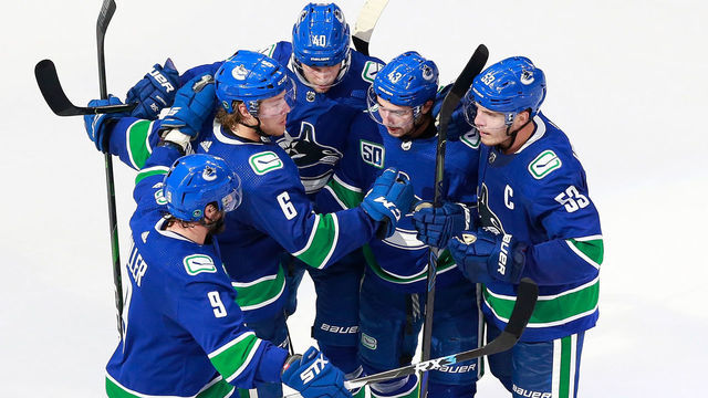 EDMONTON, ALBERTA - AUGUST 04: Bo Horvat #53 of the Vancouver Canucks celebrates his third period goal with Quinn Hughes #43, Elias Pettersson #40 and Brock Boeser #6 in Game Two of the Western Conference Qualification Round against the Minnesota Wild prior to the 2020 NHL Stanley Cup Playoffs at Rogers Place on August 04, 2020 in Edmonton, Alberta.