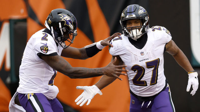 CINCINNATI, OHIO - JANUARY 03: Running back J.K. Dobbins #27 of the Baltimore Ravens celebrates with quarterback Tyler Huntley #2 after rushing for a second half touchdown against the Cincinnati Bengalsat Paul Brown Stadium on January 03, 2021 in Cincinnati, Ohio.