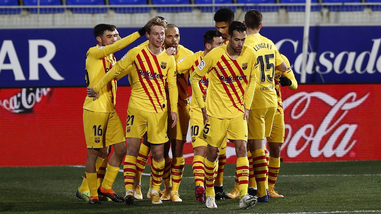 HUESCA, SPAIN - JANUARY 03: Frenkie de Jong of Barcelona celebrates with teammates Pedri, Martin Braithwaite and Lionel Messi after scoring their team's first goal during the La Liga Santander match between SD Huesca and FC Barcelona at Estadio El Alcoraz on January 03, 2021 in Huesca, Spain. Sporting stadiums around Spain remain under strict restrictions due to the Coronavirus Pandemic as Government social distancing laws prohibit fans inside venues resulting in games being played behind closed doors.