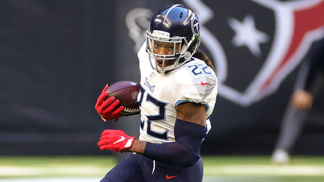 HOUSTON, TEXAS - JANUARY 03: Derrick Henry #22 of the Tennessee Titans avoids a tackle by Keion Crossen #35 of the Houston Texans during the first half at NRG Stadium on January 03, 2021 in Houston, Texas.