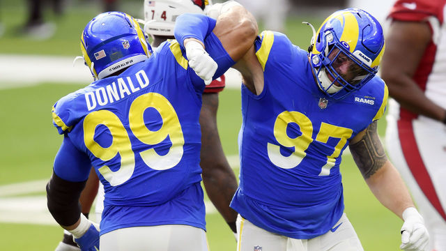 INGLEWOOD, CALIFORNIA - JANUARY 03: Aaron Donald #99 celebrates with Morgan Fox #97 of the Los Angeles Rams after a defensive play during the first half against the Arizona Cardinals at SoFi Stadium on January 03, 2021 in Inglewood, California.