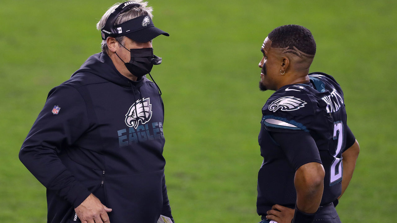 PHILADELPHIA, PENNSYLVANIA - DECEMBER 13: Head coach Doug Pederson of the Philadelphia Eagles talks with quarterback Jalen Hurts #2 in the second half against the New Orleans Saints at Lincoln Financial Field on December 13, 2020 in Philadelphia, Pennsylvania.