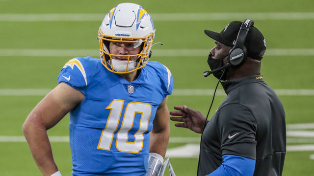 Inglewood, CA, Sunday, December 27, 2020 - Los Angeles Chargers quarterback Justin Herbert (10) and head coach Anthony Lynn talk before executing a third down play during a last minute drive against the Broncos at SoFi Stadium. (Robert Gauthier/ Los Angeles Times via Getty Images)