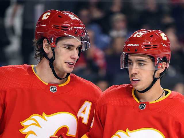 CALGARY, AB - JANUARY 18: Calgary Flames Center Sean Monahan (23) and Left Wing Johnny Gaudreau (13) talk between whistles during the second period of an NHL game where the Calgary Flames hosted the Detroit Red Wings on January 18, 2019, at the Scotiabank Saddledome in Calgary, AB.