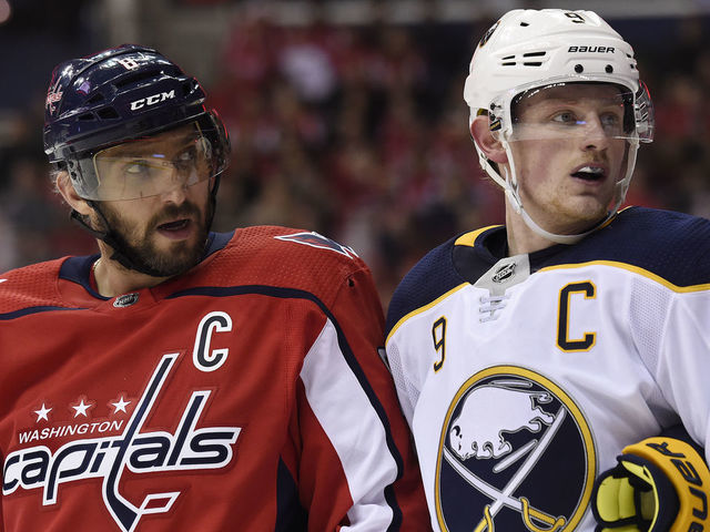 WASHINGTON, DC - DECEMBER 15: Alex Ovechkin #8 of the Washington Capitals and Jack Eichel #9 of the Buffalo Sabres look on during a stopage in play in the second period at Capital One Arena on December 15, 2018 in Washington, DC.