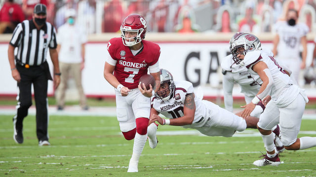 NORMAN, OK - SEPTEMBER 12: Oklahoma Sooners QB Spencer Rattler (7) evades the tackle attempt of Missouri State Bears LB Tylar Wiltz (10) during a college football game between the Oklahoma Sooners and the Missouri State Bears on September 12, 2020, at the Gaylord Family Memorial Stadium in Norman, OK.