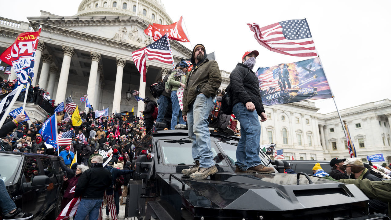 UNITED STATES - JANUARY 6: Trump supporters stand on the U.S. Capitol Police armored vehicle as others take over the steps of the Capitol on Wednesday, Jan. 6, 2021, as the Congress works to certify the electoral college votes.
