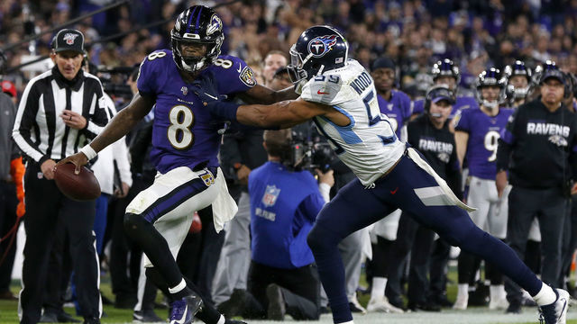 BALTIMORE, MARYLAND - JANUARY 11: Quarterback Lamar Jackson #8 of the Baltimore Ravens carries the ball against Wesley Woodyard #59 of the Tennessee Titans during the AFC Divisional Playoff game at M&T Bank Stadium on January 11, 2020 in Baltimore, Maryland.