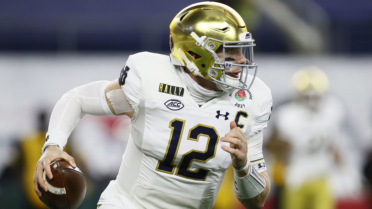 ARLINGTON, TEXAS - JANUARY 01: Quarterback Ian Book #12 of the Notre Dame Fighting Irish scrambles against the defense of the Alabama Crimson Tide during the first quarter of the 2021 College Football Playoff Semifinal Game at the Rose Bowl Game presented by Capital One at AT&T Stadium on January 01, 2021 in Arlington, Texas.