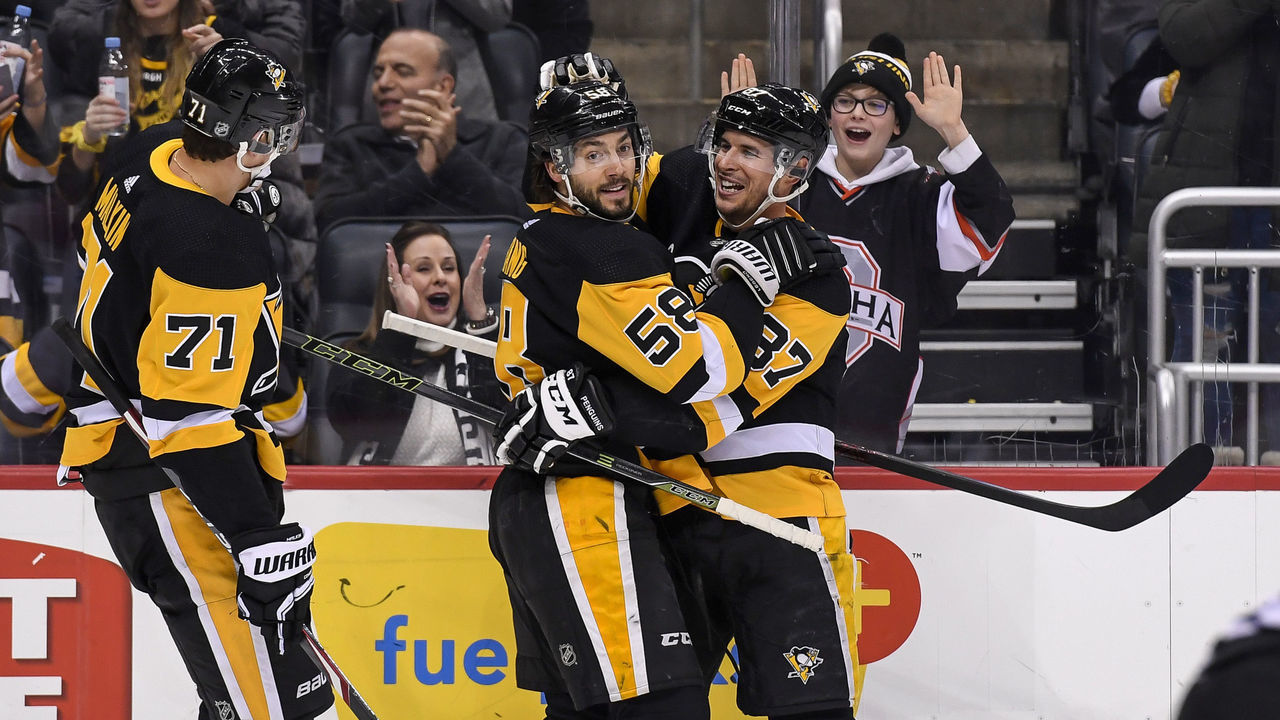 PITTSBURGH, PA - FEBRUARY 14: Pittsburgh Penguins Defenseman Kris Letang (58) celebrates after scoring a power play goal with Pittsburgh Penguins Center Sidney Crosby (87) and Pittsburgh Penguins Center Evgeni Malkin (71) during the second period in the NHL game between the Pittsburgh Penguins and the Montreal Canadiens on February 14, 2020, at PPG Paints Arena in Pittsburgh, PA.