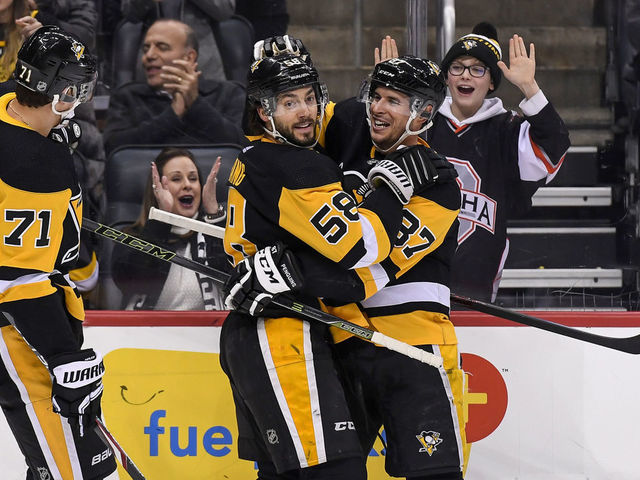PITTSBURGH, PA - FEBRUARY 14: Pittsburgh Penguins Defenseman Kris Letang (58) celebrates after scoring a power play goal with Pittsburgh Penguins Center Sidney Crosby (87) and Pittsburgh Penguins Center Evgeni Malkin (71) during the second period in the NHL game between the Pittsburgh Penguins and the Montreal Canadiens on February 14, 2020, at PPG Paints Arena in Pittsburgh, PA.