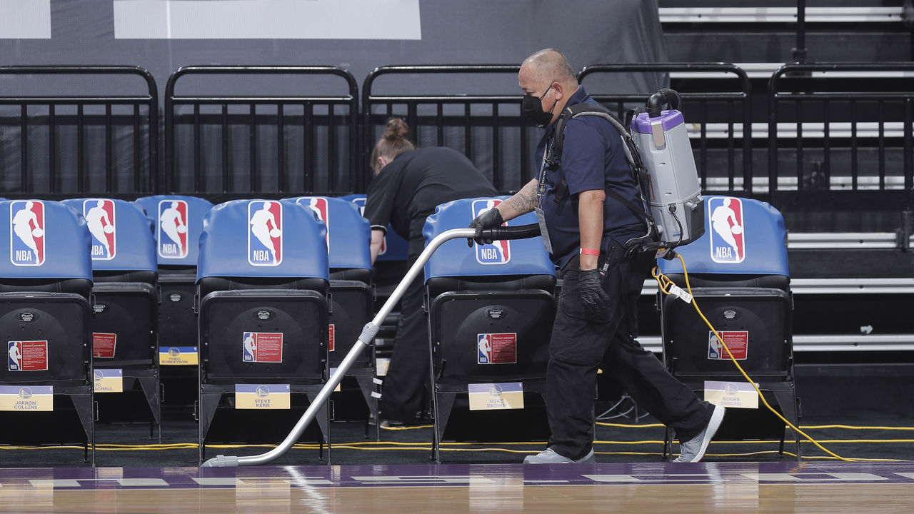 SACRAMENTO, CA - DECEMBER 17: An employee sanitizes for COVID-19 during the game between the Golden State Warriors and Sacramento Kings on December 17, 2020 at Golden 1 Center in Sacramento, California. NOTE TO USER: User expressly acknowledges and agrees that, by downloading and or using this photograph, User is consenting to the terms and conditions of the Getty Images Agreement. Mandatory Copyright Notice: Copyright 2020 NBAE