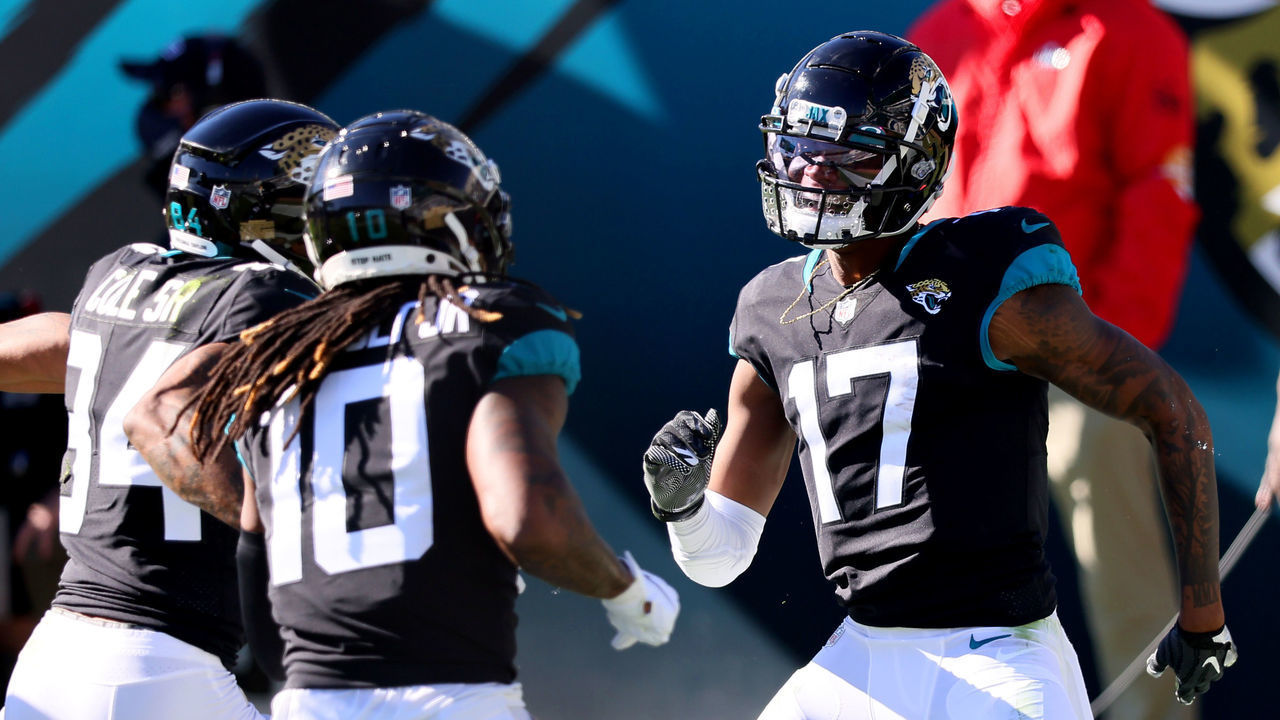 JACKSONVILLE, FLORIDA - DECEMBER 27: DJ Chark Jr. #17 of the Jacksonville Jaguars celebrates with Laviska Shenault Jr. #10 and Keelan Cole Sr. #84 after scoring a touchdown against the Chicago Bears at TIAA Bank Field on December 27, 2020 in Jacksonville, Florida.