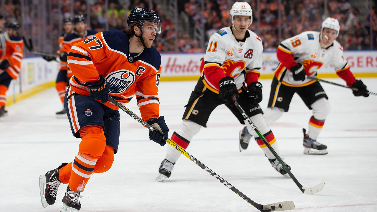 EDMONTON, AB - JANUARY 29: Connor McDavid #97 of the Edmonton Oilers skates against Mikael Backlund #11 of the Calgary Flames during the second period at Rogers Place on January 29, 2020, in Edmonton, Canada.