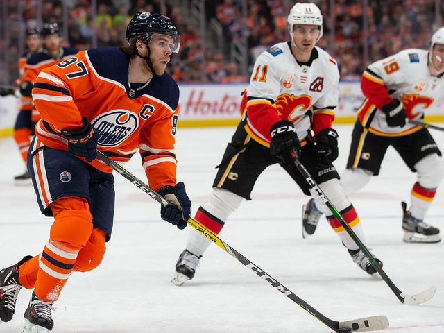EDMONTON, AB - JANUARY 29: Connor McDavid #97 of the Edmonton Oilers skates against Mikael Backlund #11 of the Calgary Flames during the second period at Rogers Place on January 29, 2020, in Edmonton, Canada.