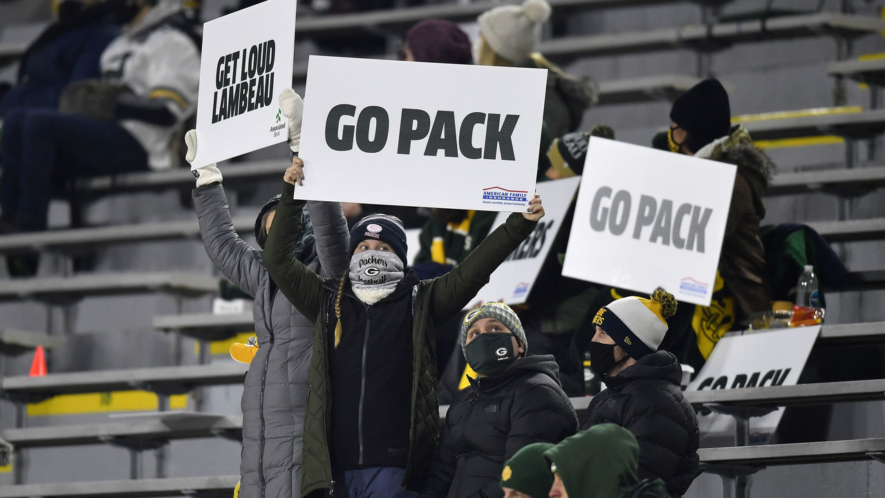 GREEN BAY, WISCONSIN - DECEMBER 19: Fans hold up signs in support of the Green Bay Packers during the game against the Carolina Panthers at Lambeau Field on December 19, 2020 in Green Bay, Wisconsin.