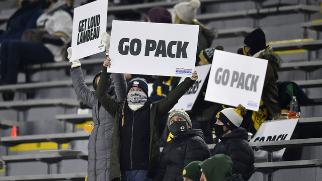 GREEN BAY, WISCONSIN - DECEMBER 19: Fans hold up signs in support of the Green Bay Packers during the game against the Carolina Panthers at Lambeau Field on December 19, 2020 in Green Bay, Wisconsin.