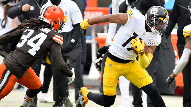 CLEVELAND, OHIO - JANUARY 03: JuJu Smith-Schuster #19 of the Pittsburgh Steelers carries the ball against Robert Jackson #34 of the Cleveland Browns in the second quarter at FirstEnergy Stadium on January 03, 2021 in Cleveland, Ohio.