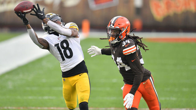 CLEVELAND, OHIO - JANUARY 03: Wide receiver Diontae Johnson #18 of the Pittsburgh Steelers catches a pass while under pressure from cornerback Robert Jackson #34 of the Cleveland Browns during the first half at FirstEnergy Stadium on January 03, 2021 in Cleveland, Ohio. The Browns defeated the Steelers 24-22.