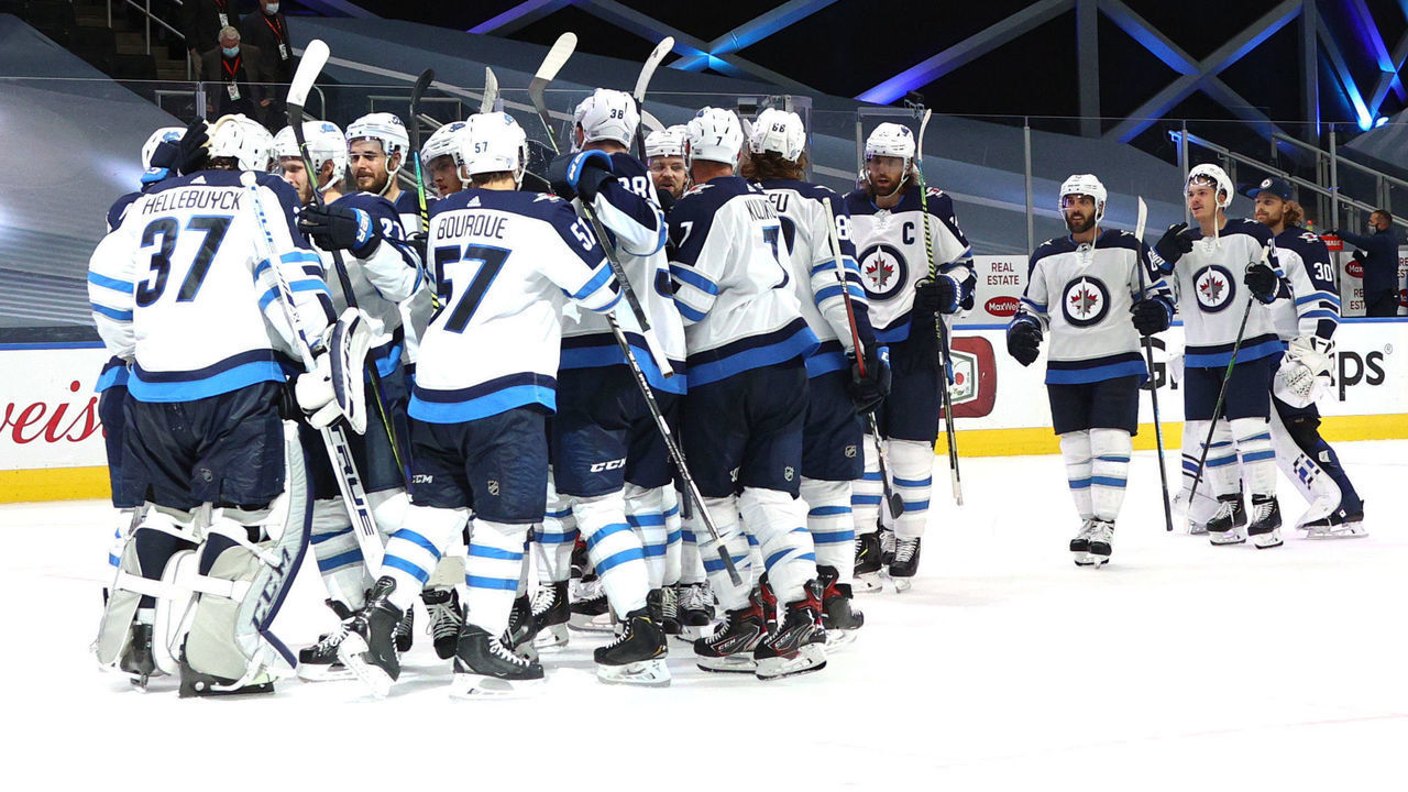 EDMONTON, ALBERTA - AUGUST 03: The Winnipeg Jets celebrate defeating the Calgary Flames 3-2 in Game Two of the Western Conference Qualification Round prior to the 2020 NHL Stanley Cup Playoffs at Rogers Place on August 03, 2020 in Edmonton, Alberta.