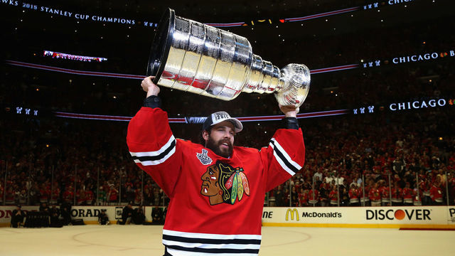 CHICAGO, IL - JUNE 15: Goaltender Corey Crawford #50 of the Chicago Blackhawks lifts the Stanley Cup in celebration after his team defeated the Tampa Bay Lightning 2-0 in Game Six of the 2015 NHL Stanley Cup Final at the United Center on June 15, 2015 in Chicago, Illinois.