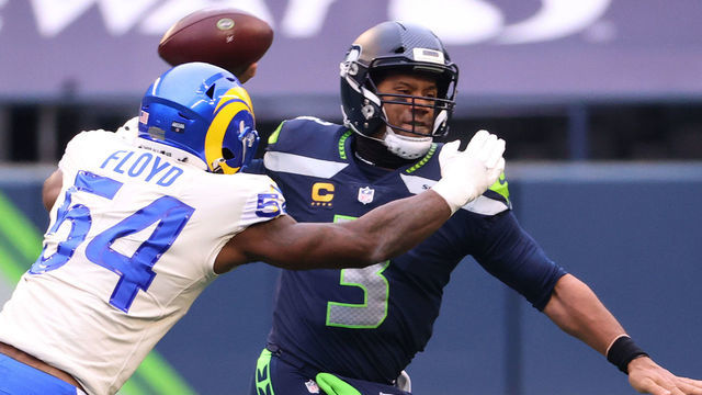 SEATTLE, WASHINGTON - JANUARY 09: Quarterback Russell Wilson #3 of the Seattle Seahawks has a pass broken up by outside linebacker Leonard Floyd #54 of the Los Angeles Rams during the second quarter of the NFC Wild Card Playoff game at Lumen Field on January 09, 2021 in Seattle, Washington.
