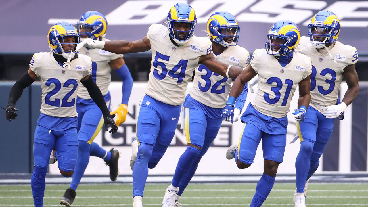 SEATTLE, WASHINGTON - JANUARY 09: Defensive back Darious Williams #31 of the Los Angeles Rams celebrates with teammates Leonard Floyd #54 and Troy Hill #22 after Williams returned an interception for a touchdown during the second quarter of the NFC Wild Card Playoff game against the Seattle Seahawks at Lumen Field on January 09, 2021 in Seattle, Washington.
