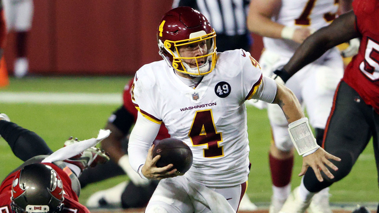 LANDOVER, MARYLAND - JANUARY 09: Quarterback Taylor Heinicke #4 of the Washington Football Team scrambles during the 3rd quarter of the game against the Tampa Bay Buccaneers at FedExField on January 09, 2021 in Landover, Maryland.