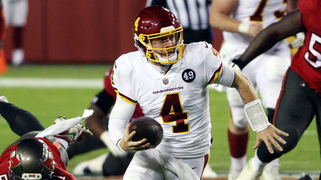 LANDOVER, MARYLAND - JANUARY 09: Quarterback Taylor Heinicke #4 of the Washington Football Team scrambles during the 3rd quarter of the game against the Tampa Bay Buccaneers at FedExField on January 09, 2021 in Landover, Maryland.